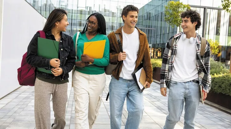 Quatre jeunes étudiants se promènent à l'extérieur